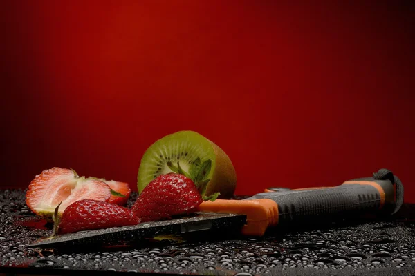 Färsk frukt med vatten droppar på dem och kniv — Stockfoto