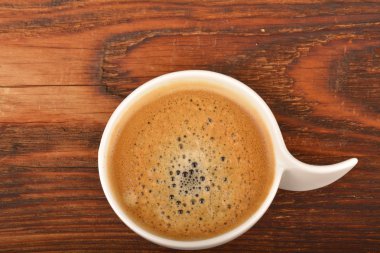 Kahve fincanı ahşap masada.