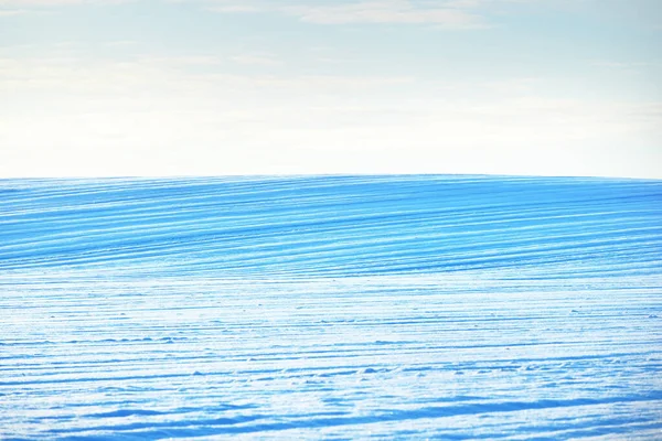 Breathtaking panoramic view of snow-covered field after a blizzard at sunset. Lapland, Finland. Dramatic cloudscape. Winter wonderland. Ice desert. Ecology, weather, climate change, global warming