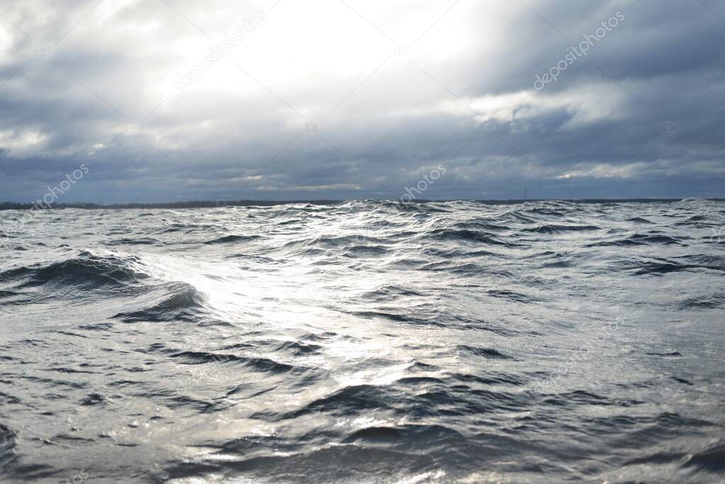 North sea under the dark clouds after the thunderstorm. A view from the sailing boat. Dramatic stormy sky. Epic cloudscape. Norway. Cyclone in winter. Ecology, global warming concepts