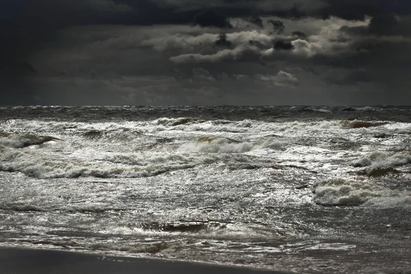 Baltic sea under the dark dramatic clouds after thunderstorm. Latvia. Epic seascape. Cyclone, gale, storm, rough weather, meteorology, ecology, climate change, natural phenomenon