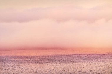 The shore of Pointe de Pen Hir in a clouds of morning fog at sunrise. Brittany, France. Fairy colors. Idyllic seascape. Travel destinations theme