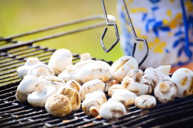 Kömür mantarı ızgarası ve yakın plan sigara. Mutfak, sağlıklı beslenme, yaşam tarzı, organik, vejetaryen, vegan yemekleri, yemek pişirme, yaz tatilleri teması