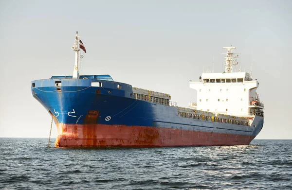 stock image Large blue cargo ship anchored in Strait of Gibraltar. A view from the yacht, close-up of anchor chain. Summer Atlantic sailing near Spain and Africa. Freight transport, global communications theme