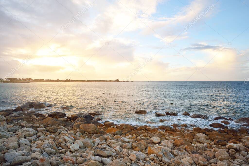 Rocky ocean coastline in Plouguerneau, Brittany, France. Epic sunset glowing clouds. Picturesque panoramic view. Idyllic landscape. Pure nature, environment, eco tourism, sailing, cruise