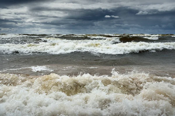 Baltic sea under the dark dramatic clouds after thunderstorm. Latvia. Epic seascape. Cyclone, gale, storm, rough weather, meteorology, ecology, climate change, natural phenomenon