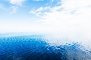 Açık ve güneşli bir günde Akdeniz manzarası nefes kesici, İspanya. Beyaz bulutlu mavi gökyüzü, suda yansımalar.