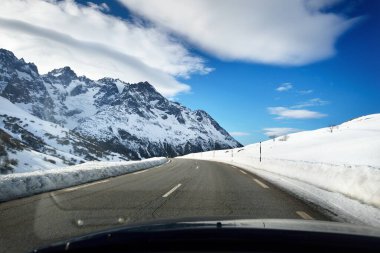 An empty highway in a French Alps mountains. A view from the car stucked near the border of Italy because of travel ban. Coronavirus (COVID-19) outbreak, quarantine zone in Parc Ecrins, France clipart