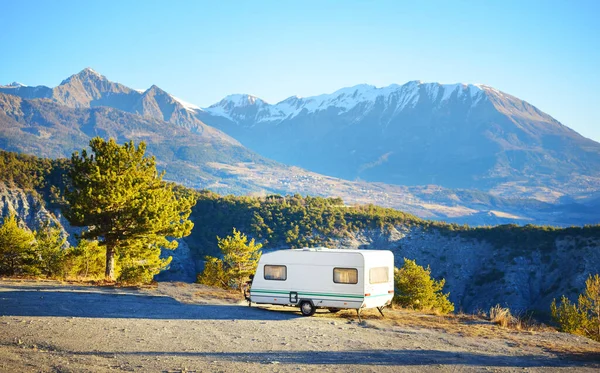 Caravan trailer stucked near the border of Italy because of travel ban, close-up. Coronavirus (COVID-19) outbreak, quarantine zone in France. An empty highway in a French Alps mountains on a clear day