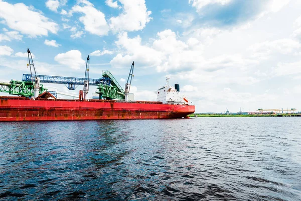 Large red cargo crane ship, close-up. Port of Riga, Latvia