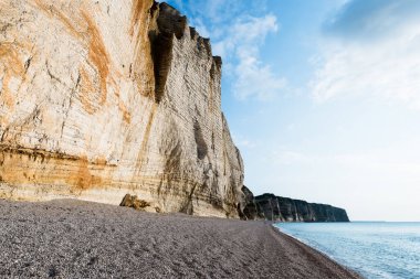 Gün batımında Etretat beyaz kayalıklarının manzarası. Bulutlu mavi gökyüzü. Normandiya, Fransa