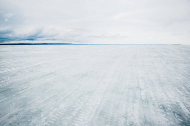 Kış manzarası. Donmuş karla kaplı göl manzarası. Arka planda orman var. Fırtınalı akşam bulutları. Onega Gölü, Karelia, Rusya