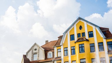 Bulutlu mavi gökyüzüne karşı fayanslı çatısı olan güzel eski bir ev, Almanya