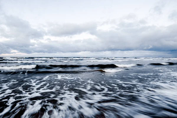 Cold stormy waves and clouds over the North sea, Netherlands