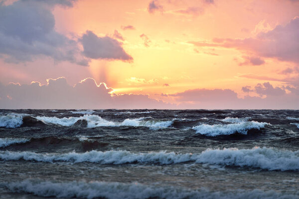 Stunning sunset sky, Baltic Sea, Denmark. Storm waves and colorful clouds. Long exposure