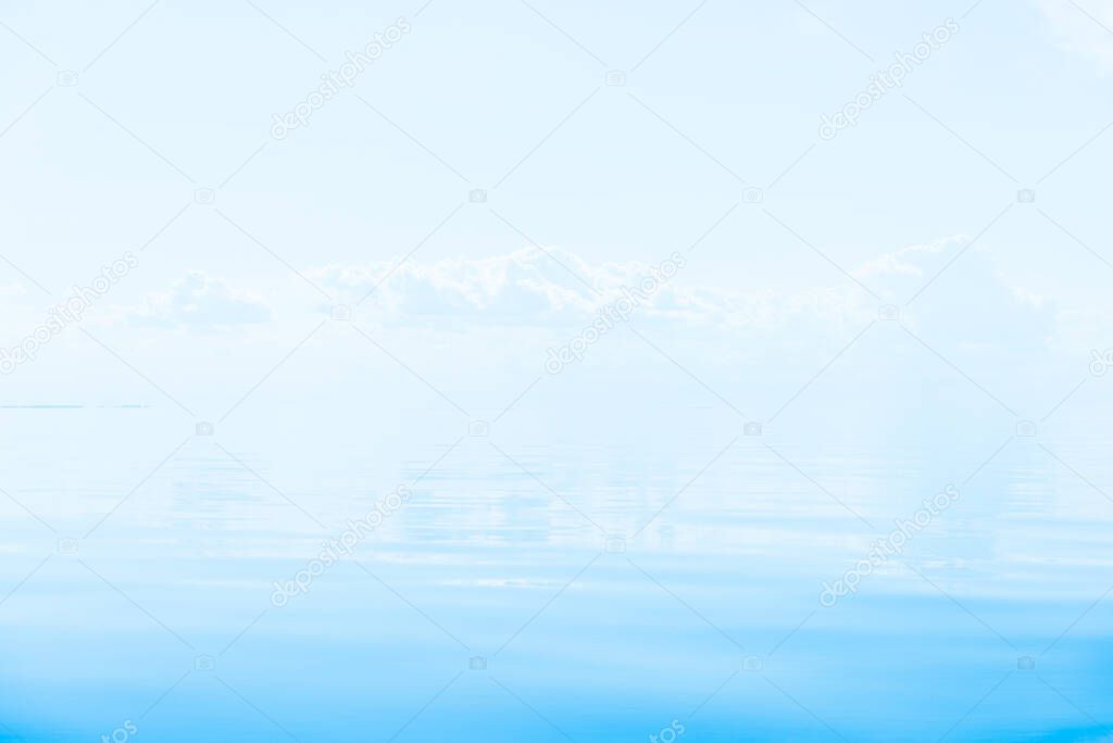 Breathtaking view of the Mediterranean sea on a clear sunny day, Spain. Blue sky with white clouds, reflections on water