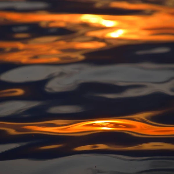 落日的近处在开阔的海面上荡漾 — 图库照片