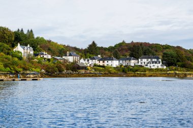 Traditional stone and brick country houses on the rocky shore of Tarbert, Scotland, UK. Architecture, travel destinations, national landmark, recreation, eco tourism, vacations, adventure, exploring clipart