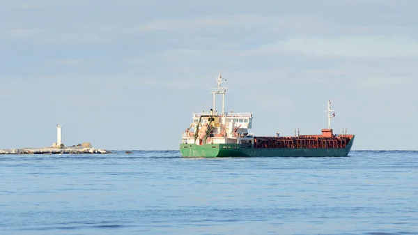 Cargo ship leaving port — Stock Photo, Image