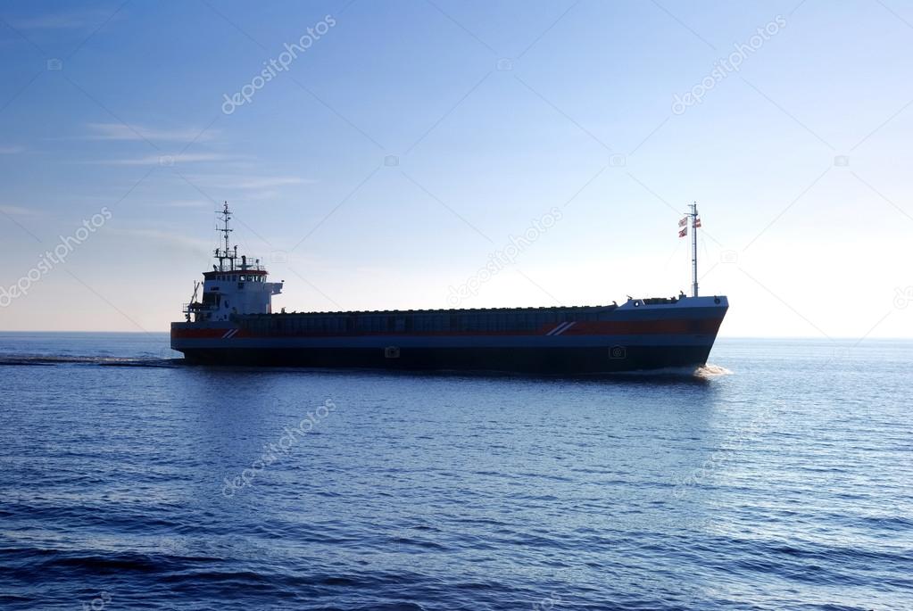 cargo ship sailing in still water