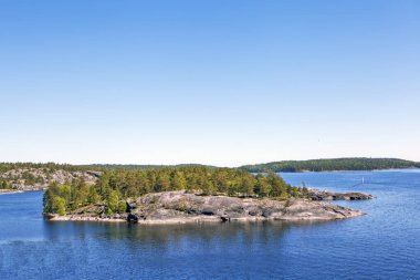 Baykal sularındaki küçük kayalık adanın mavi gökyüzü ve parlak güneş ışığı manzarası