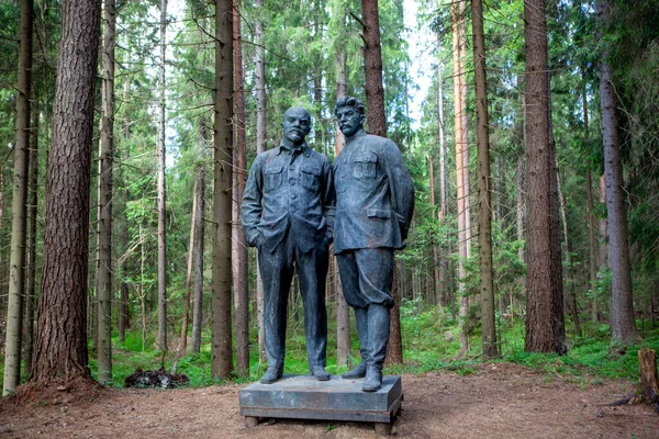 stock image lenin and stalin monument in lush green forest