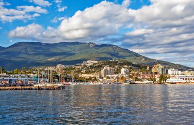 Binaları ve tepeleri olan güneşli sahil manzarası, Yalta, Ukrayna