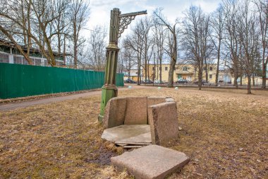 Taştan bir Gotik kuyusu ve vinç şeklinde dökme demir bir kaldıracı. Oryol Parkı. Strelna. St. Petersburg 'da. - Rusya. 10 Nisan 2021