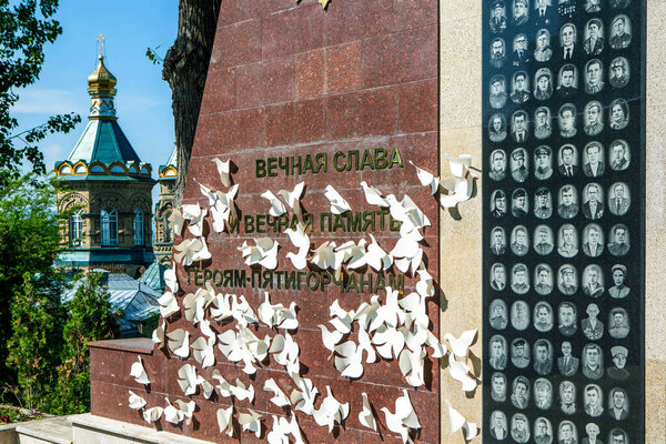 War memorial with paper white doves in the background of the Lazarevskaya church. Pyatigorsk. Stavropol region. Russia. May 21, 2021