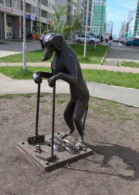 Arka ayakları üzerinde duran köpek anıtı, ve ön yüzünde bir süpürge ve toz tavası vardır. 2 Haziran 2015. Ekaterinburg, Rusya Federasyonu.
