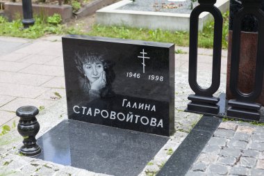 ST. PETERSBURG, RUSSIA -  AUGUST13, 2015: Photo of Monument Galina Starovoitova. Nikolskoye cemetery clipart
