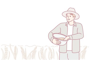 Tarım işçisi gün ışığında buğday topluyor, kırsal kesim çiftçisi güneşli tarlaların ve hafif rüzgarların arasında mahsul topluyor, tarla işçisi özenle olgun buğdayı derli toplu bir ifadeyle berrak gökyüzünün altında topluyor.