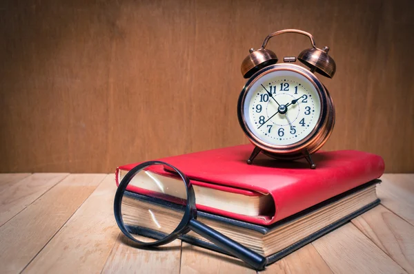 Retro alarm clock and book. Stock Picture