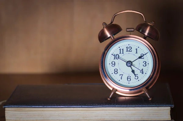 Alarm clock and book. — Stock Photo, Image