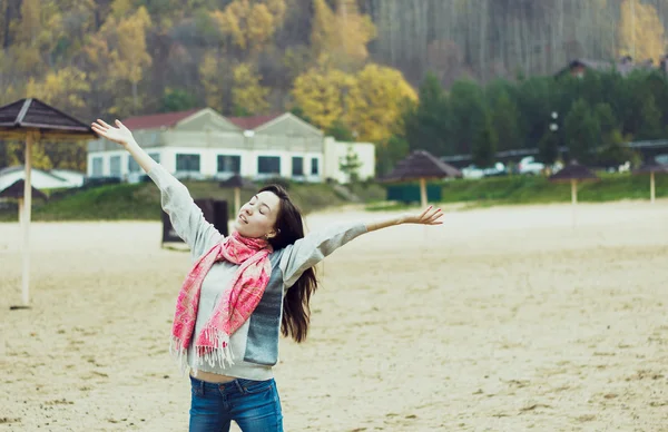 Happy beautiful young woman on the cold beach — Stock Photo, Image