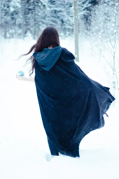 Witch in black cloak with magiс ball — Stock Photo, Image