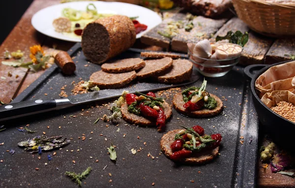 Tahıl ekmeği ve masanın üzerine farklı baharatlar.