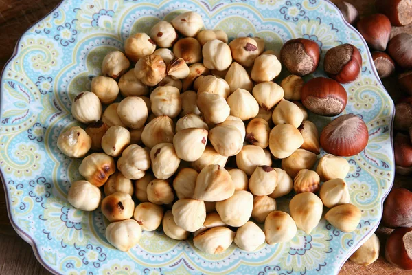 Roasted hazelnuts on a saucer. — Stock Photo, Image