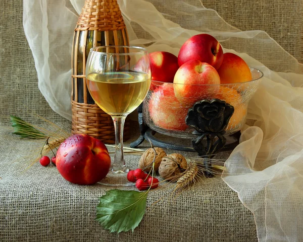 Glass of white wine, nectarines and walnuts — Stock Photo, Image