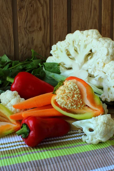 Cauliflower, carrots, bell pepper and celery on a blackboard — Stock Photo, Image