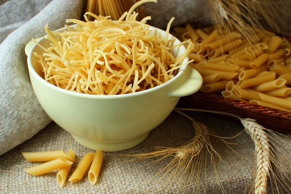 Noodles in a plate and spaghetti on the table — Stock Photo, Image