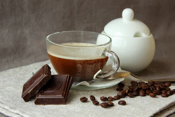 Cup of brewed coffee, chocolate and coffee beans — Stock Photo, Image