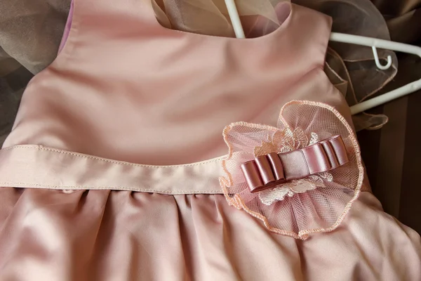 Children's silk dress with a decorative element on the belt