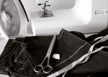 Processing bottom jeans with the aim of shortening the trouser clipart