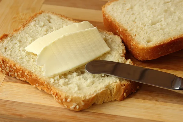 Sandwich with butter and knife — Stock Photo, Image