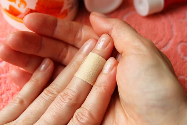 Glued plaster cut on his finger — Stock Photo, Image