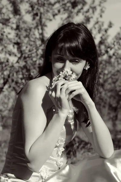 Beautiful girl on a background of flowering garden — Stock Photo, Image