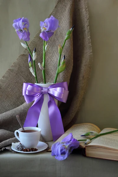 Stilleven met een boeket van iris en boek — Stockfoto