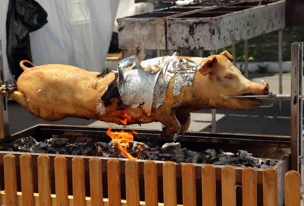 Pig roasted on a spit, cooked BBQ Festival