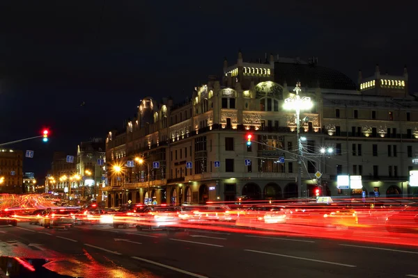 Nocny widok na ulicy z ślady od reflektory samochodów — Zdjęcie stockowe